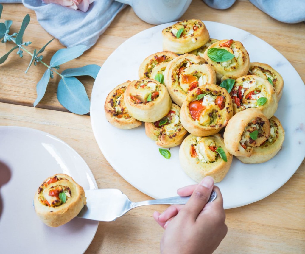 Cherry tomato, basil pesto and feta pinwheels Nadia Lim